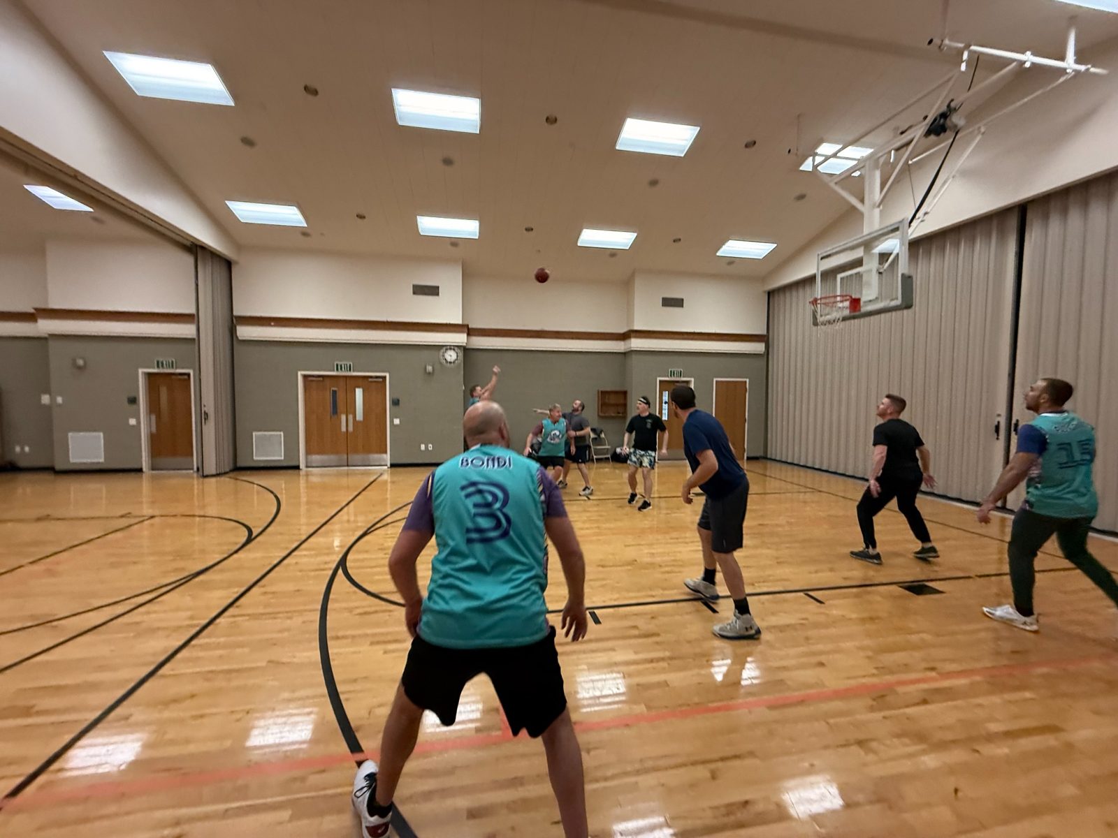Dad Bod League basketball action shot in the gym